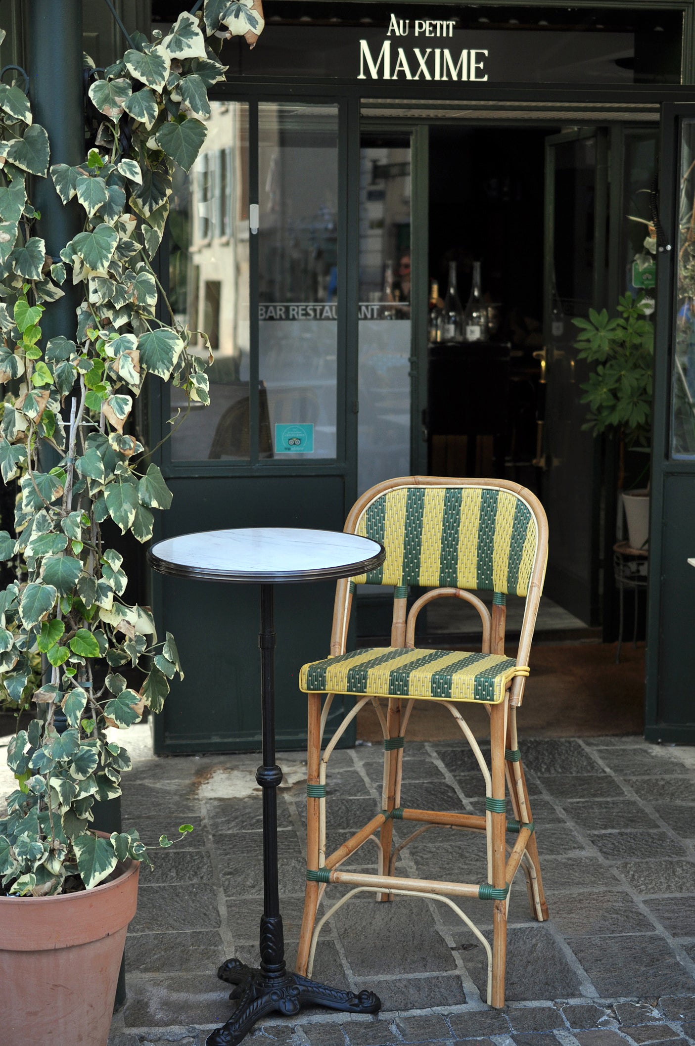 Our bar height bistro table and chair in a restaurant in France.